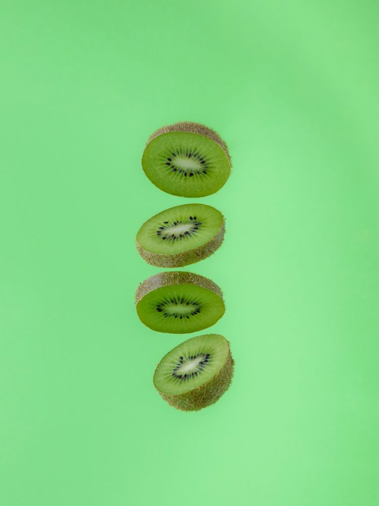 Kiwi slices showing the skin and green flesh