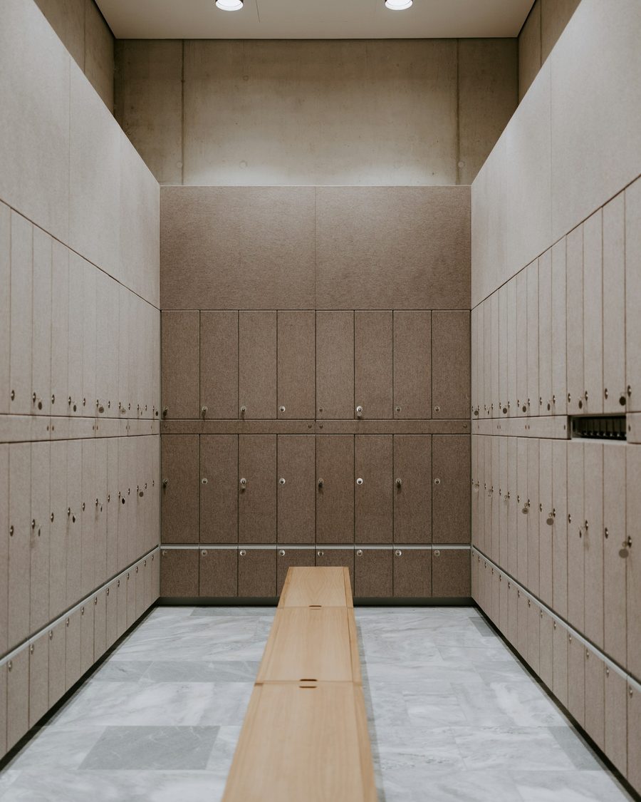 An empty locker room with a wooden bench